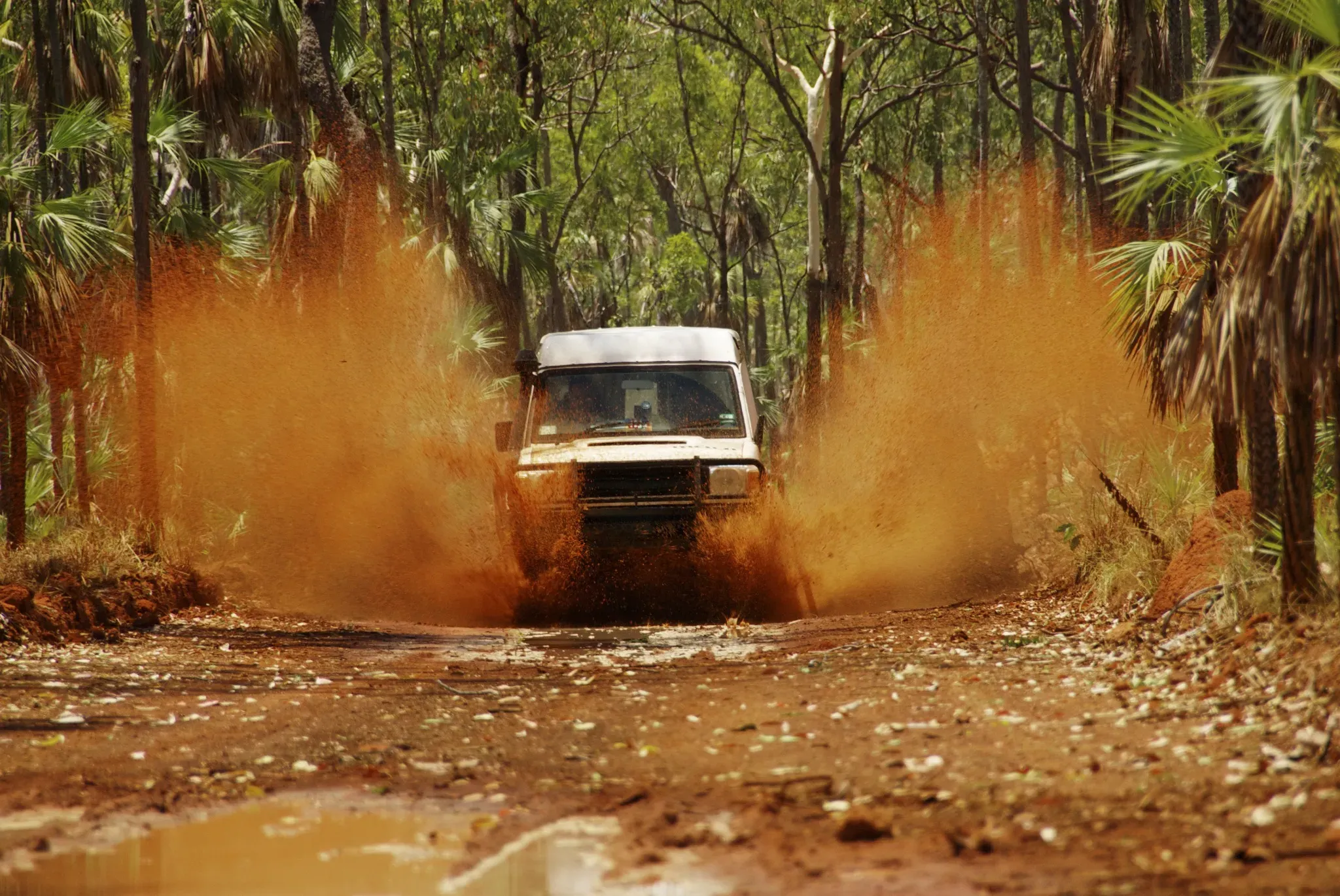 Off-road vehicle driving through mud in Costa Rica