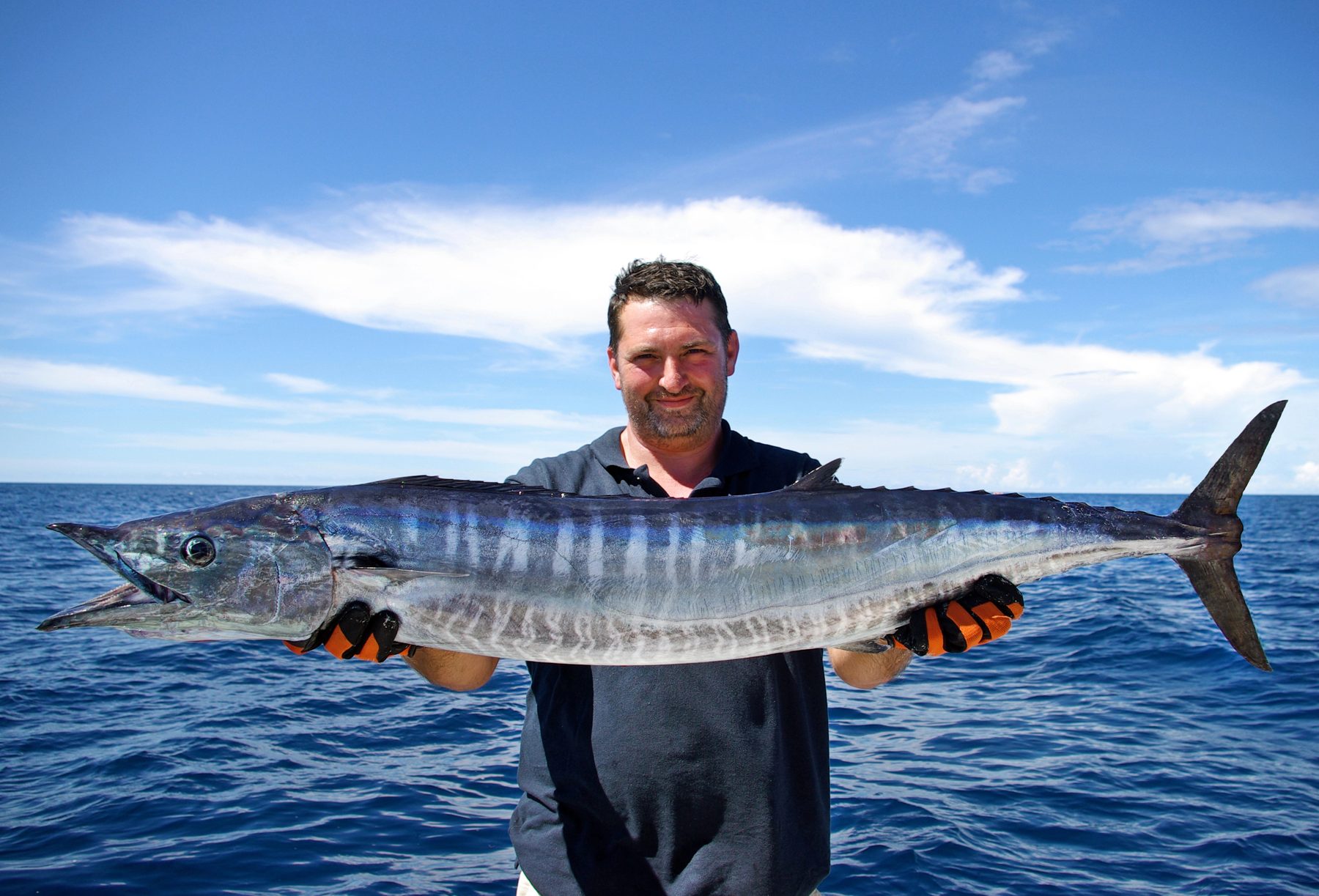 Angler holding a wahoo on a fishing boat in Costa Rica