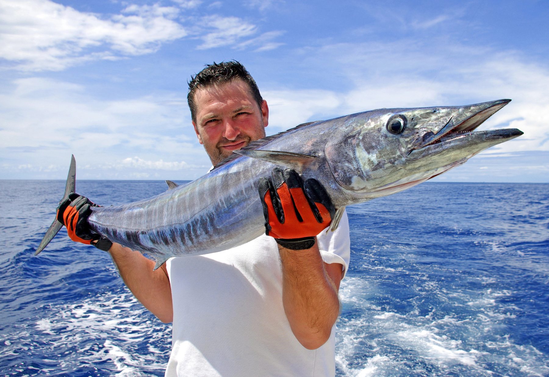 Angler holding a wahoo on a sport fishing charter in Costa Rica