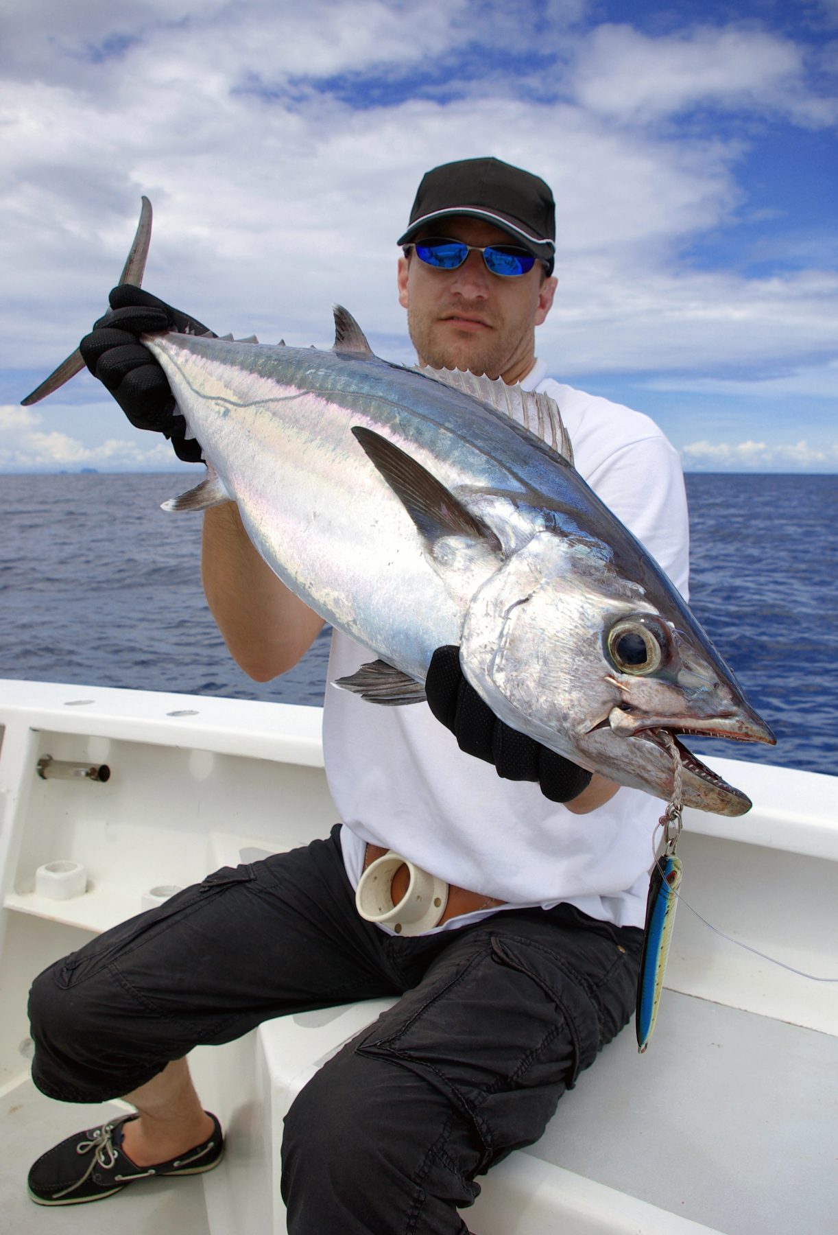 Angler holding a yellowfin tuna on an offshore charter from Quepos, Costa Rica