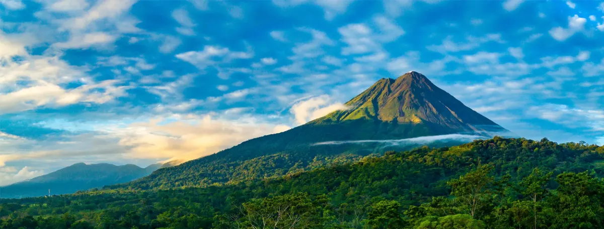 Il vulcano Arenal sotto un cielo azzurro luminoso in Costa Rica
