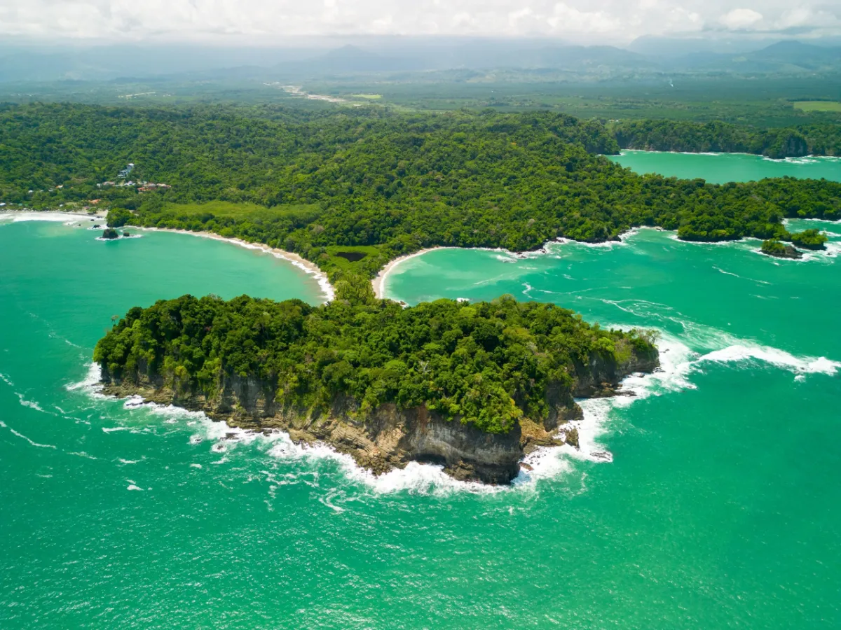 A lush green island in turquoise water on the Costa Rica coast